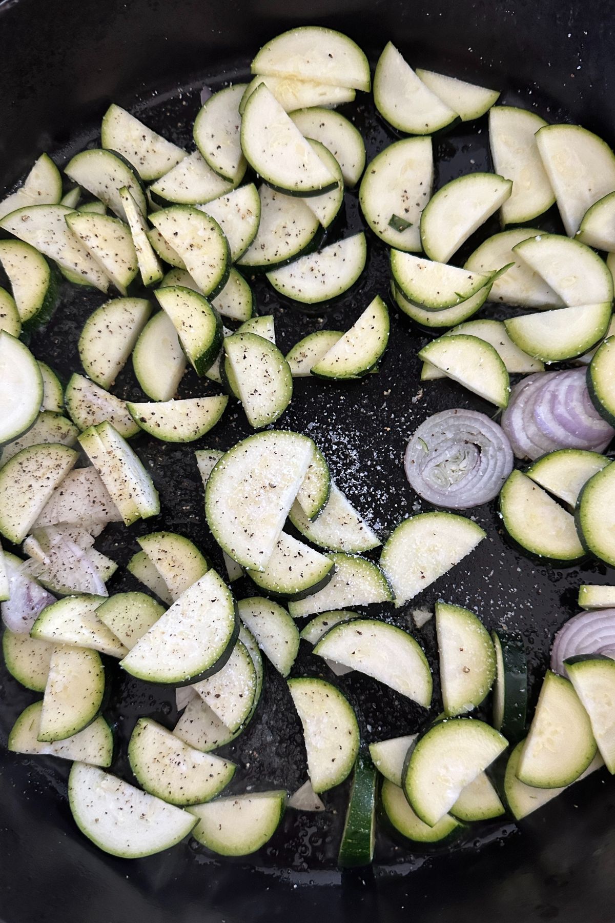 Zucchini and shallots caramelizing in skillet for pasta salad