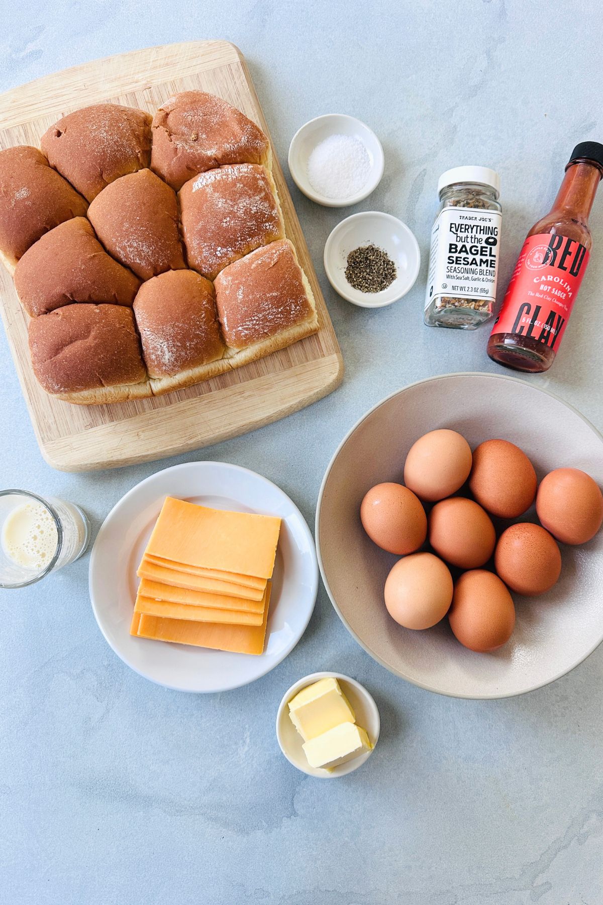 Recipe ingredients for breakfast sliders laid out on a white countertop.