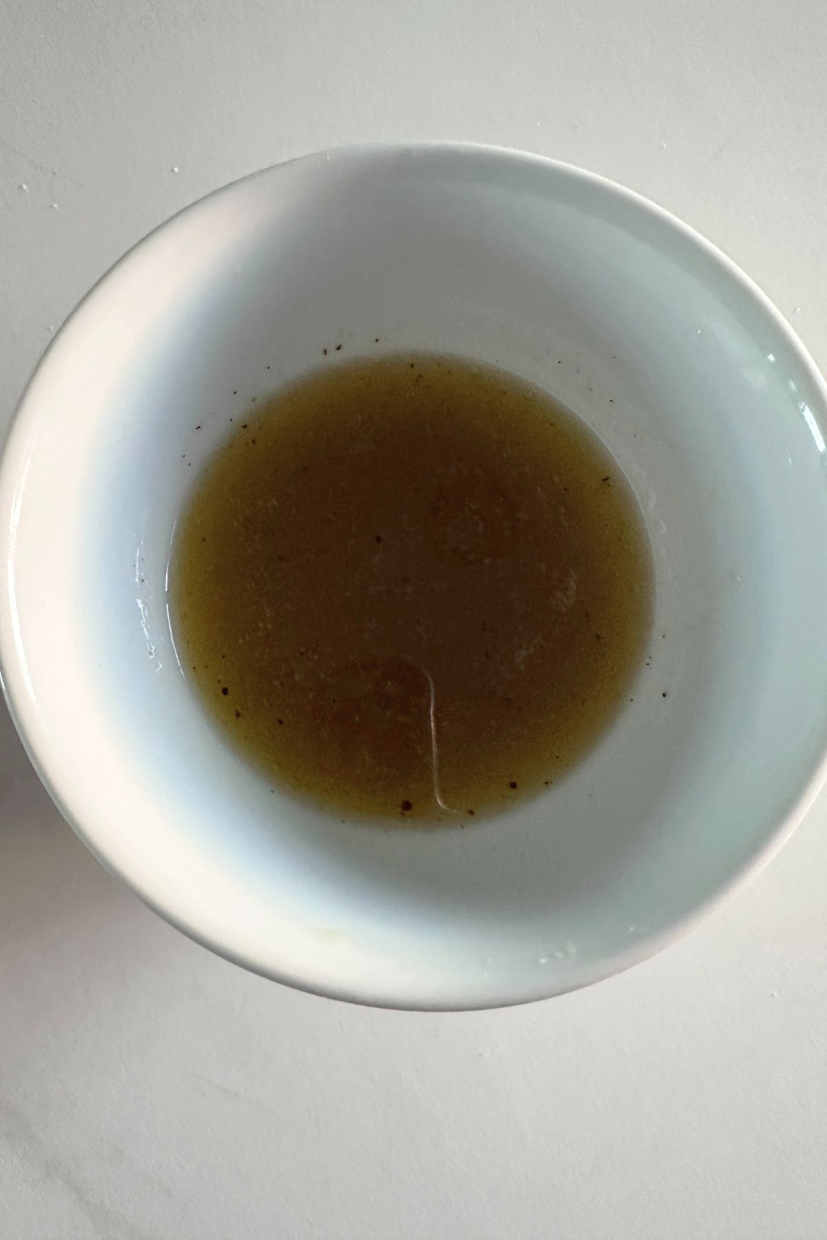 Mixed maple vinaigrette in a small bowl before tossing with greens.