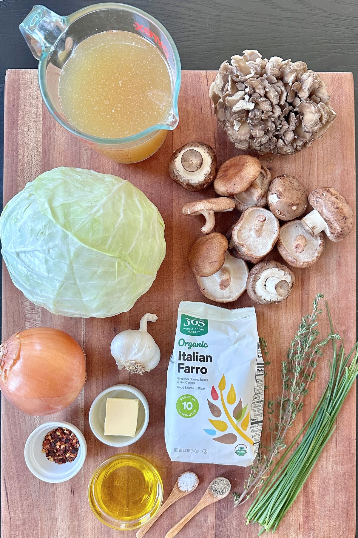 Charred cabbage recipe ingredients laid out on a wooden cutting board.