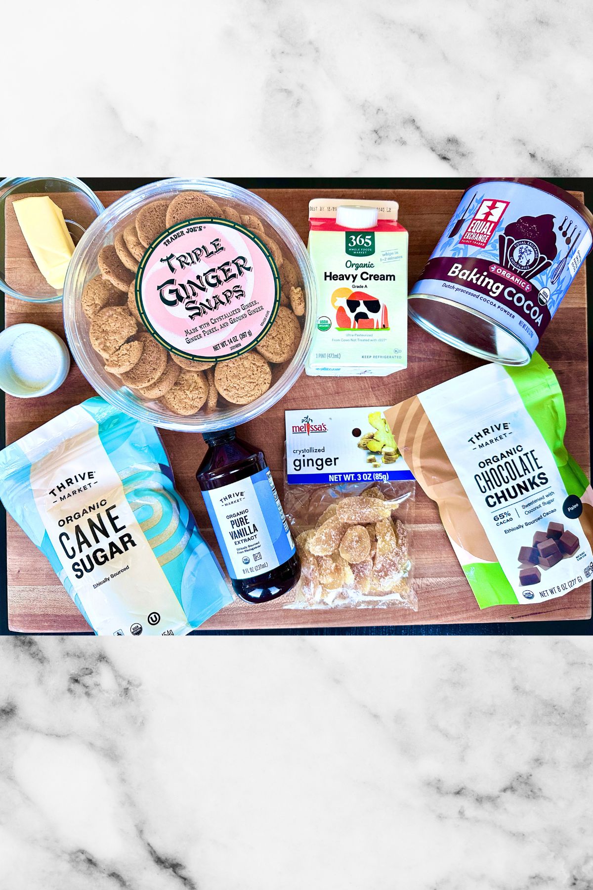 Ingredients for gingersnap pie crust laid out on a wooden cutting board.
