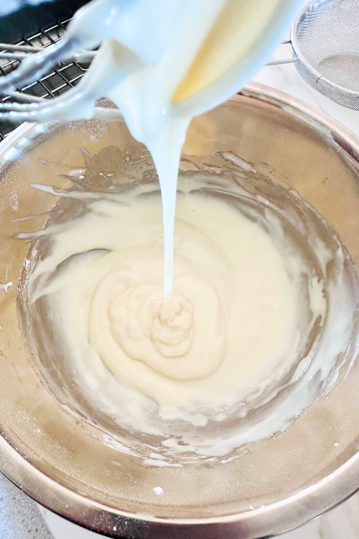 Coconut bundt cake glaze in a mixing bowl.