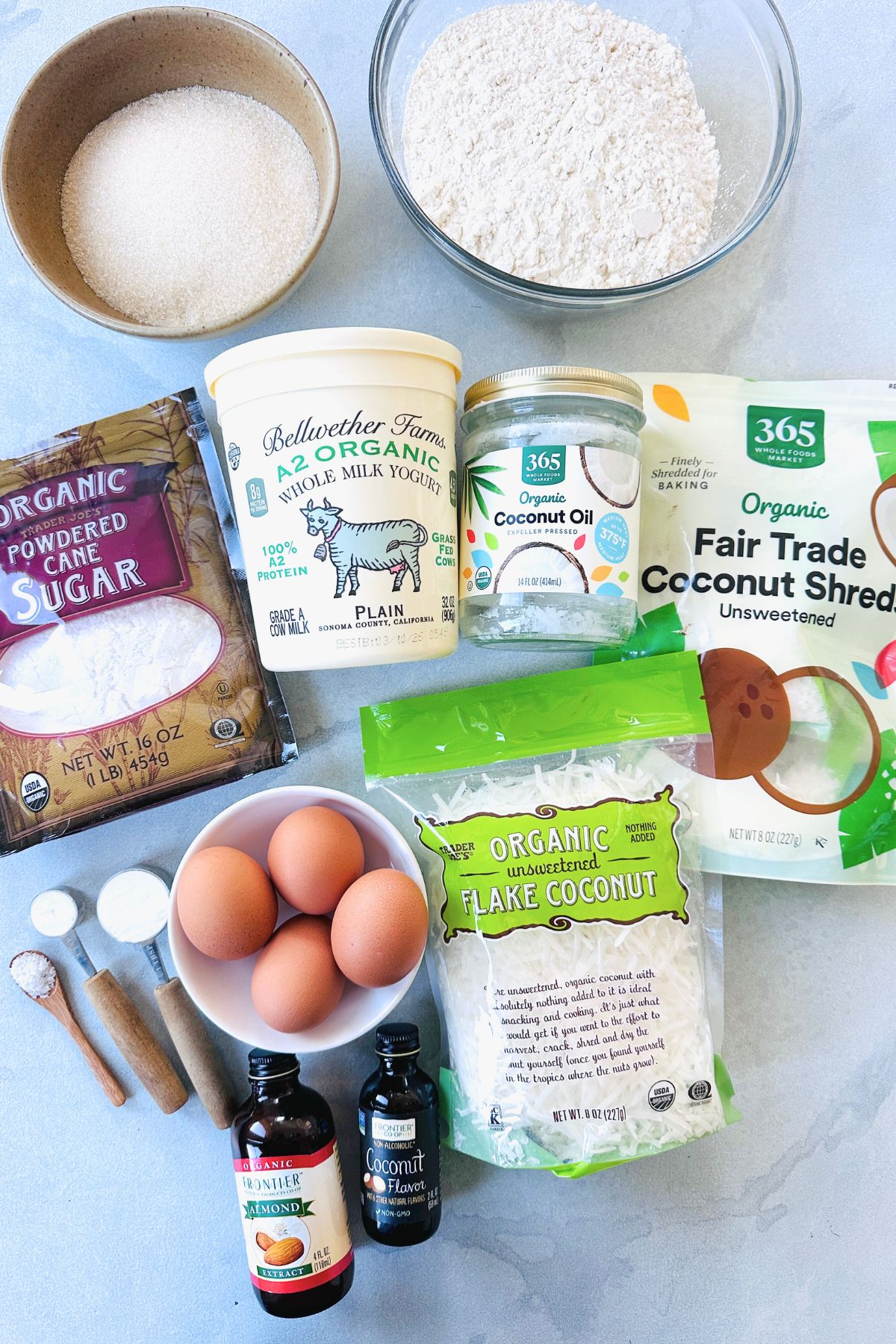 Coconut bundt cake recipe ingredients laid out on a white countertop.
