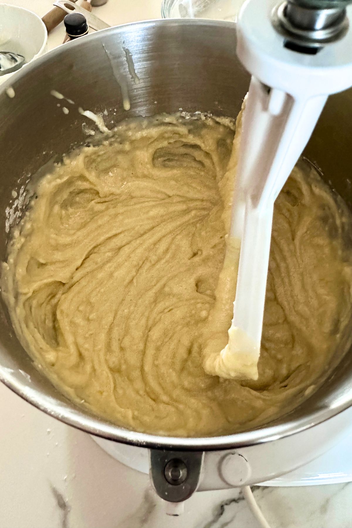 Coconut bundt cake batter in a mixing bowl.