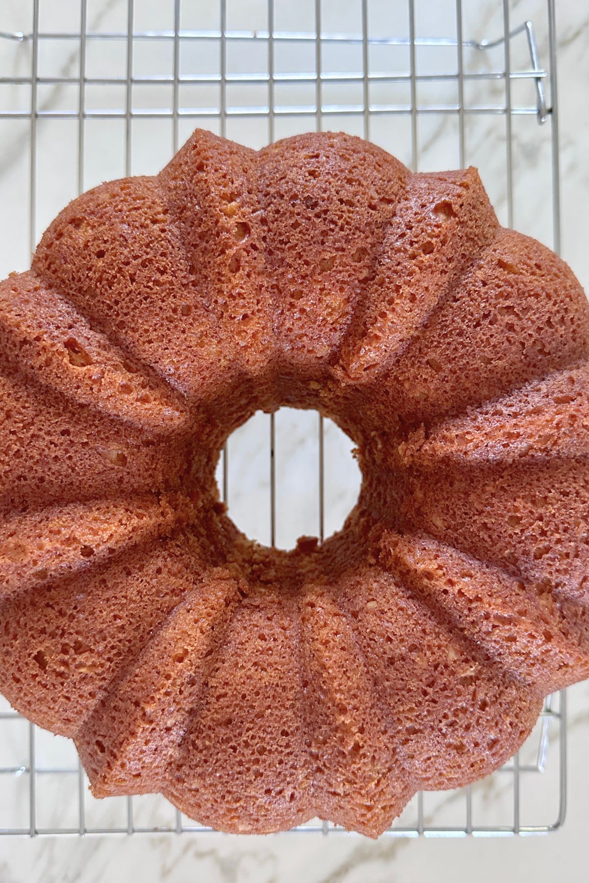 Coconut bundt cake cooling on a wire rack.