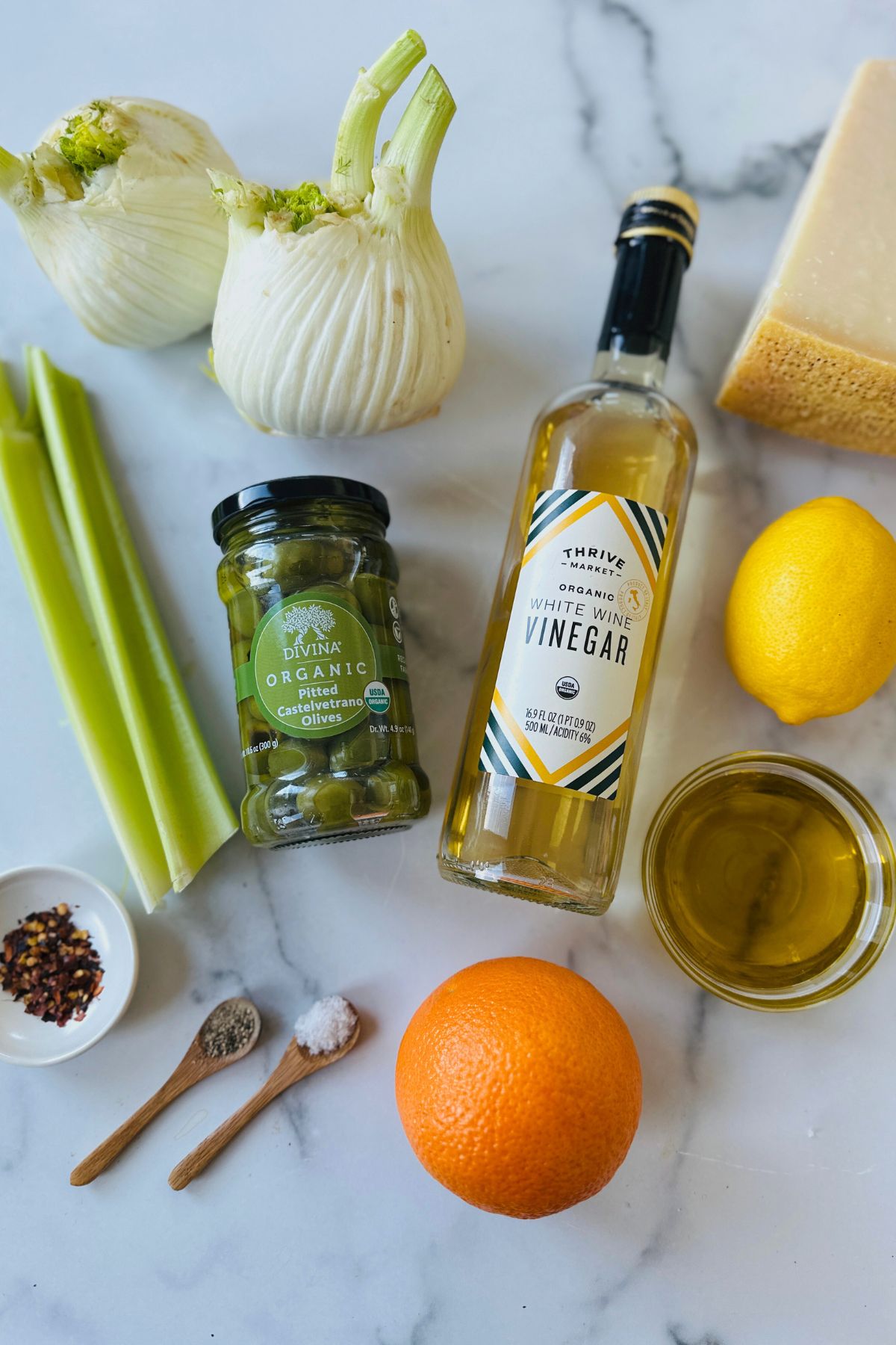 Fennel salad recipe ingredients laid out on a countertop.
