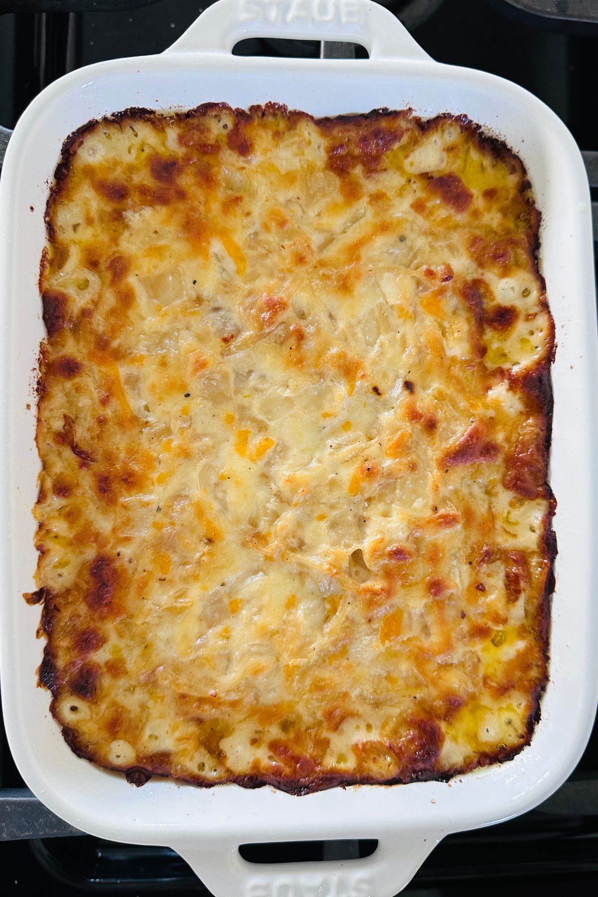 Hot onion dip fresh from the oven with golden brown edges.