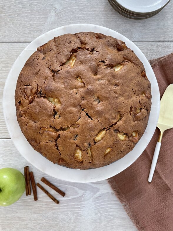 an overhead shot of an apple spice cake on a serving platter 