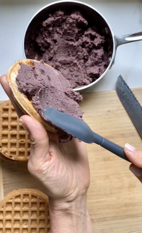 spreading beans on waffles