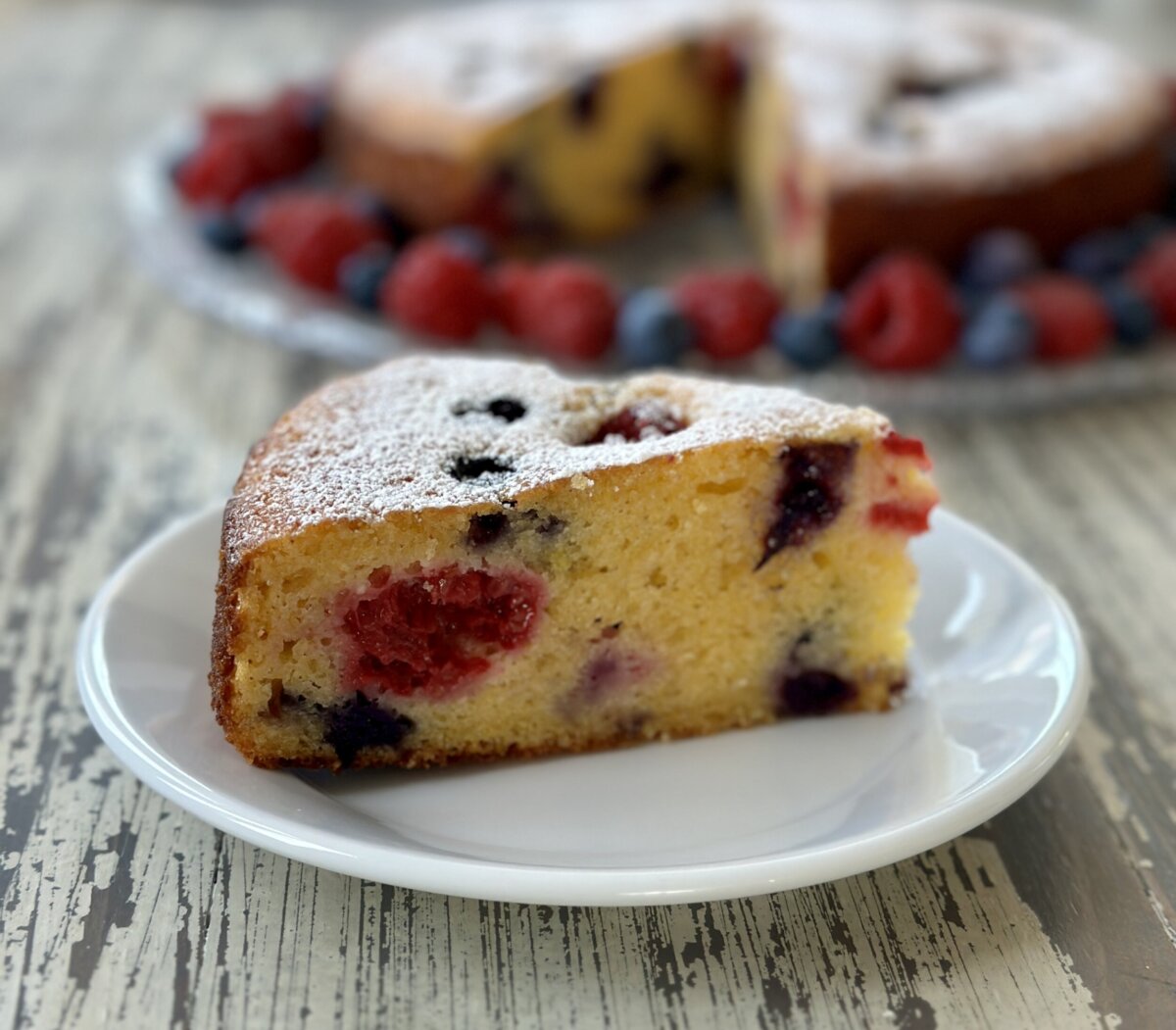 a slice of rictotta cake on a white plate