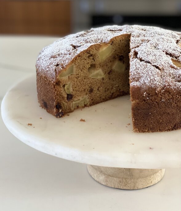a slice taken out of a cake on a stand 