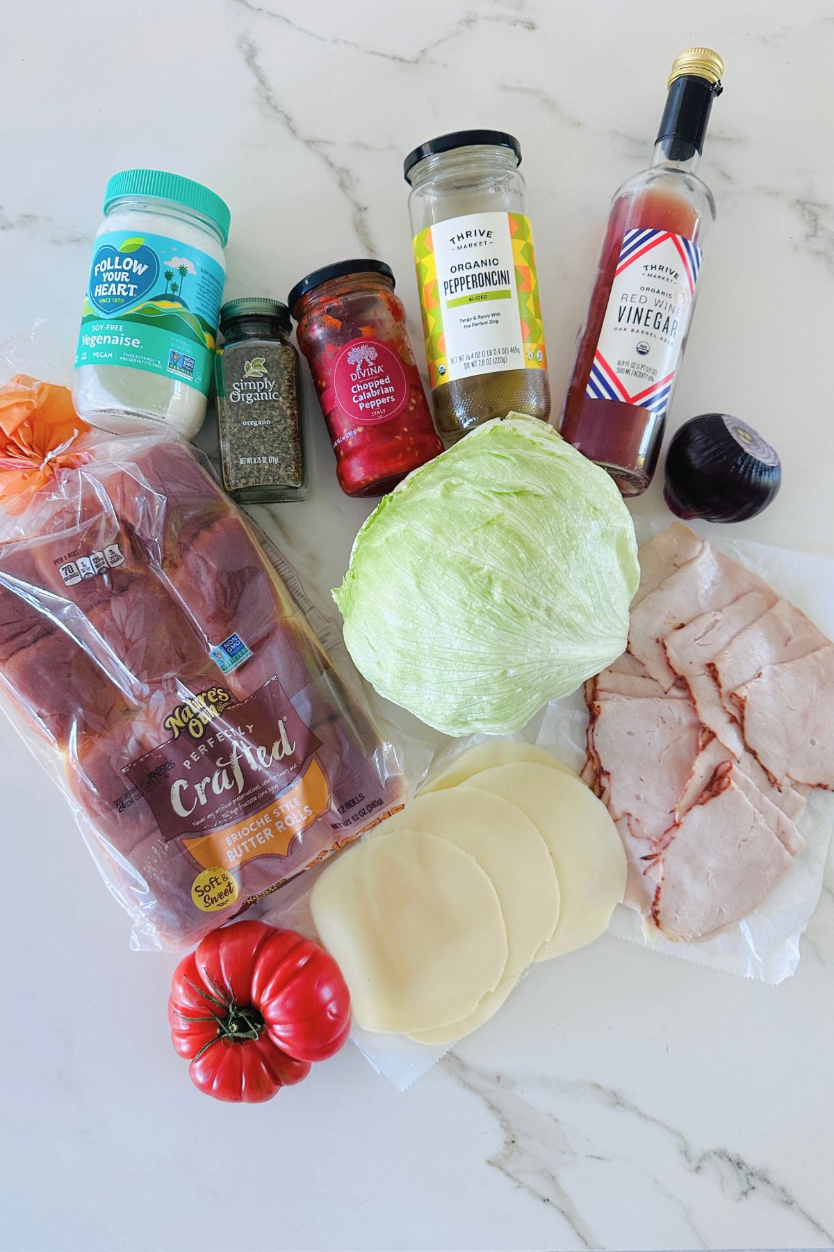 Italian grinder slider ingredients laid out on a white countertop.