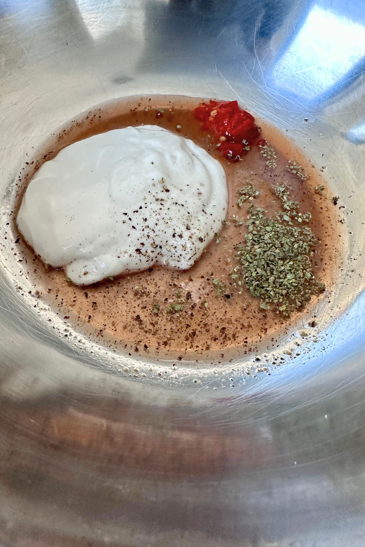 Mayonnaise, red wine vinegar, salt, pepper, oregano, and Calabrian chiles in a large bowl.