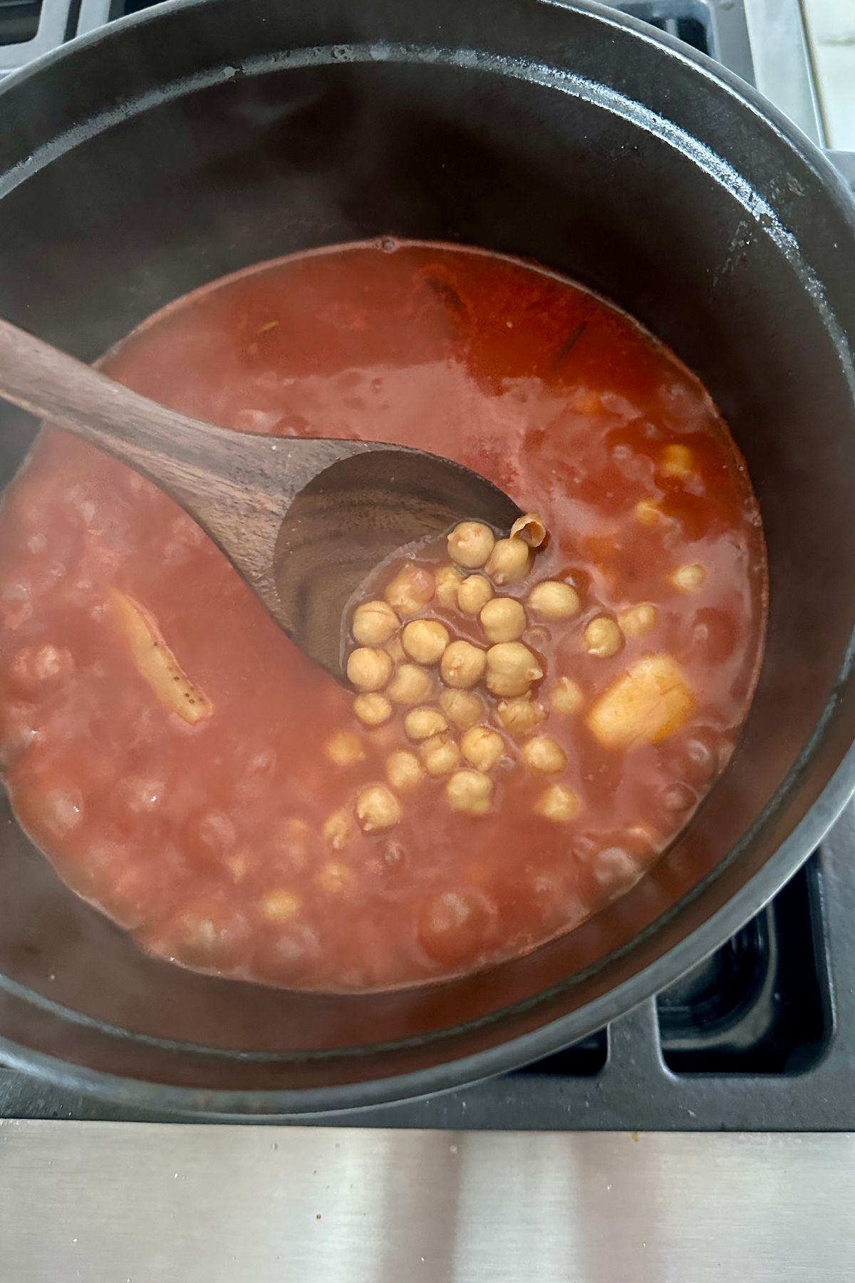 Ditalini pasta simmering in chickpea broth until tender for Pasta e Ceci.