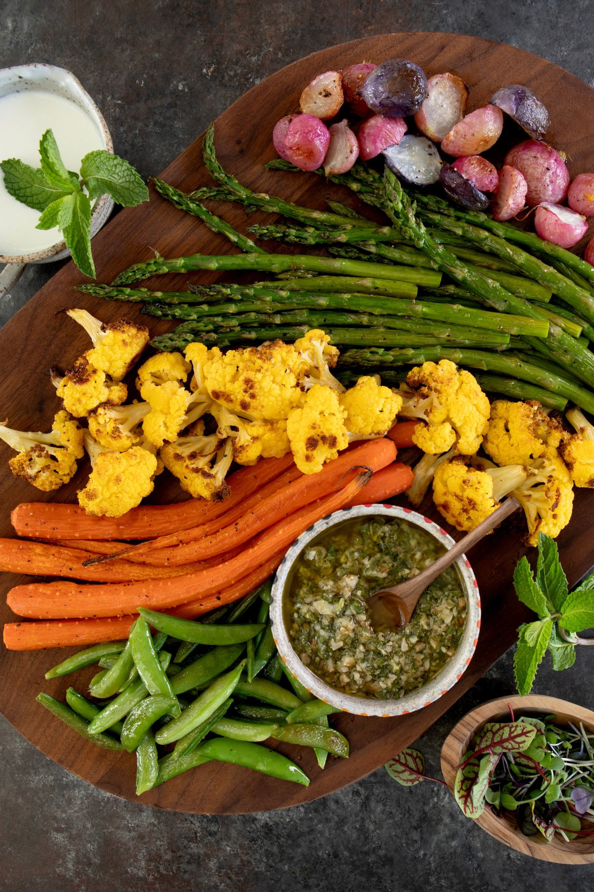 roasted veggies next to whipped feta dip and mint pesto