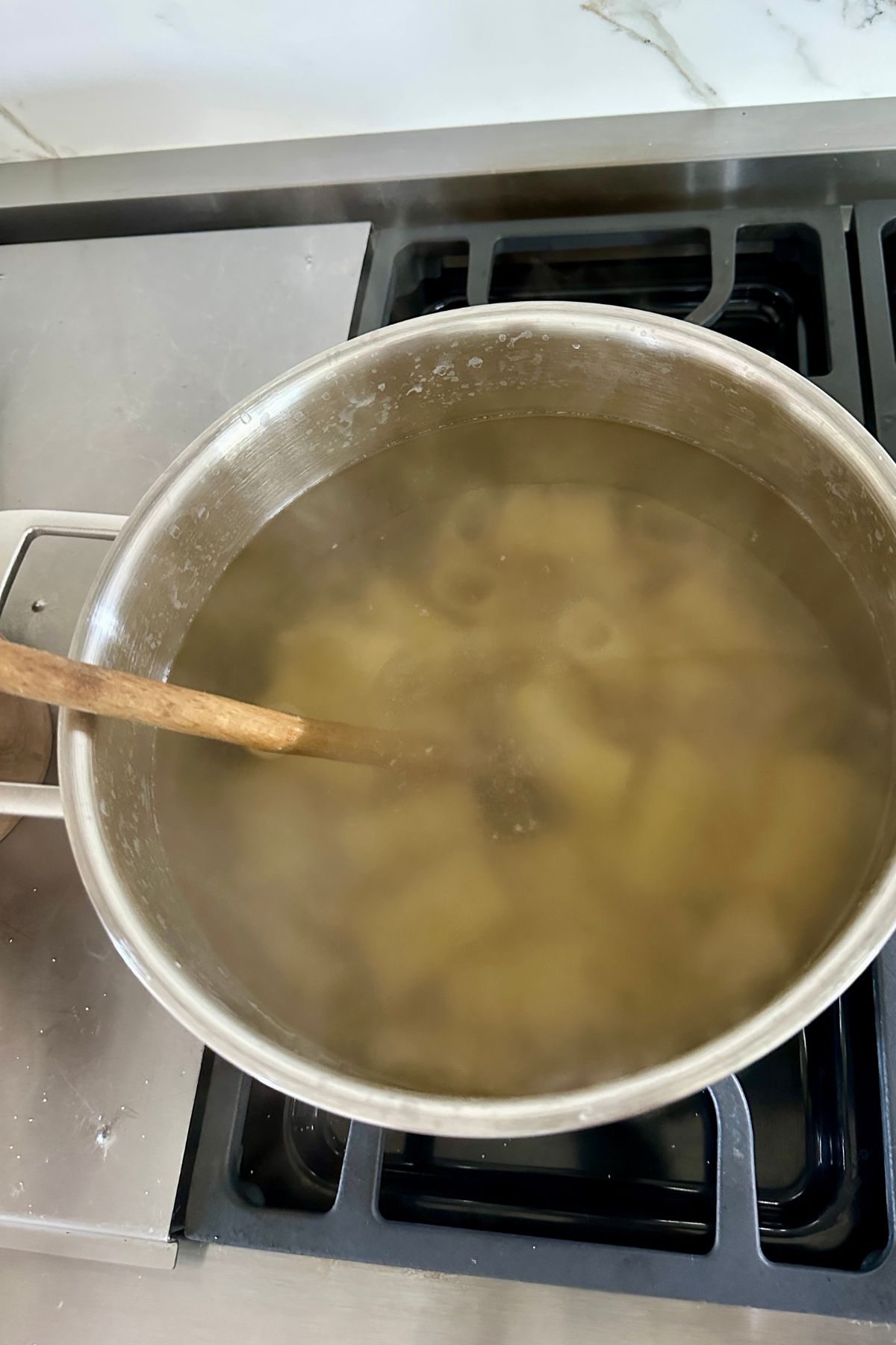 a large pot of pasta boiling in water. 