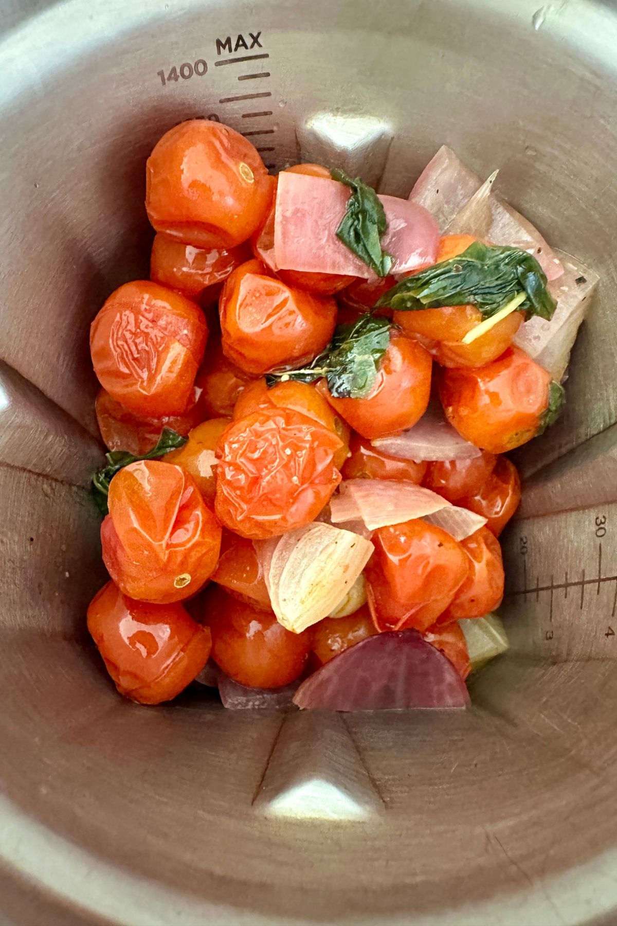 roasted veggies put into a blender to blend into a roasted tomato pasta sauce 