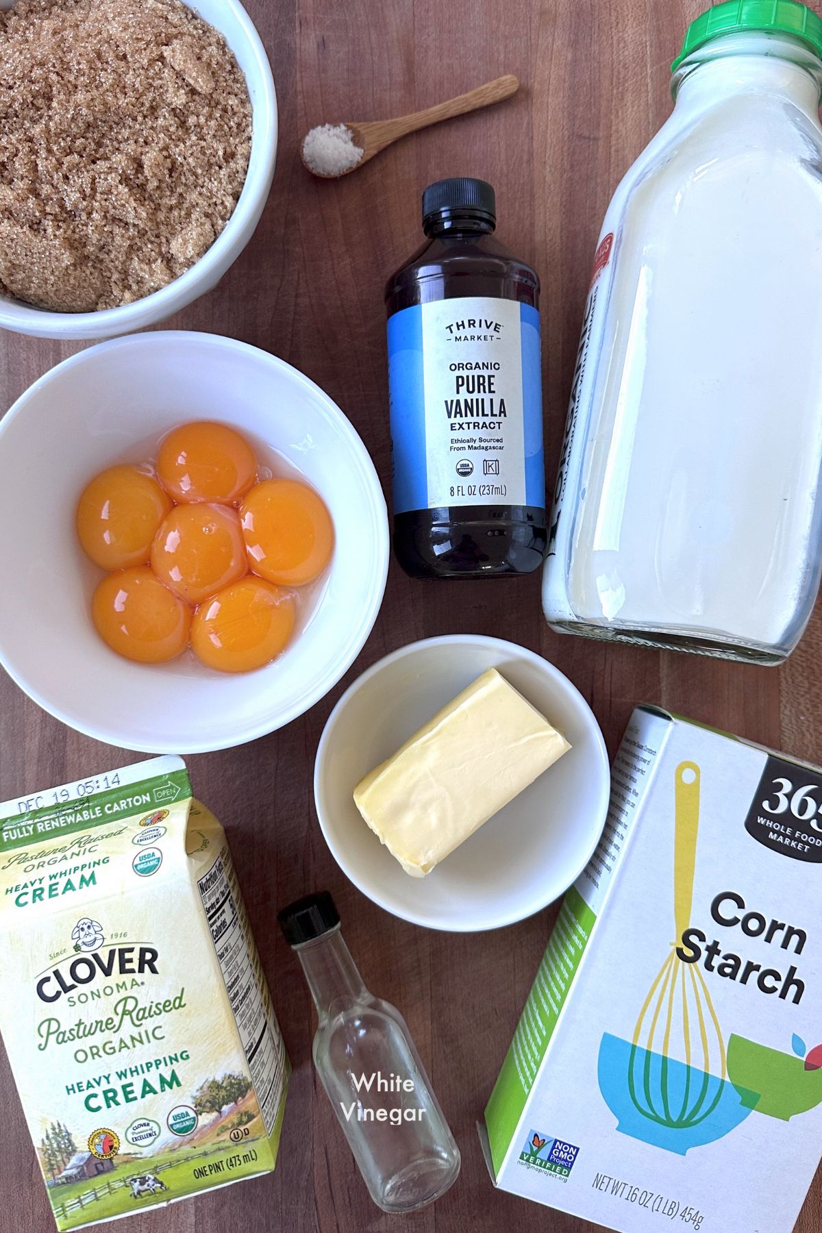 Pudding parfait recipe ingredients arranged on a dark wooden countertop.