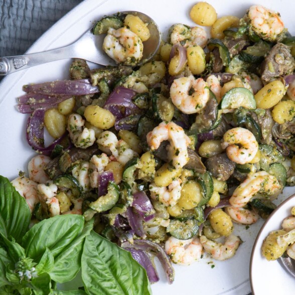 sheet pan gnocchi on a serving platter with shrimp and pesto