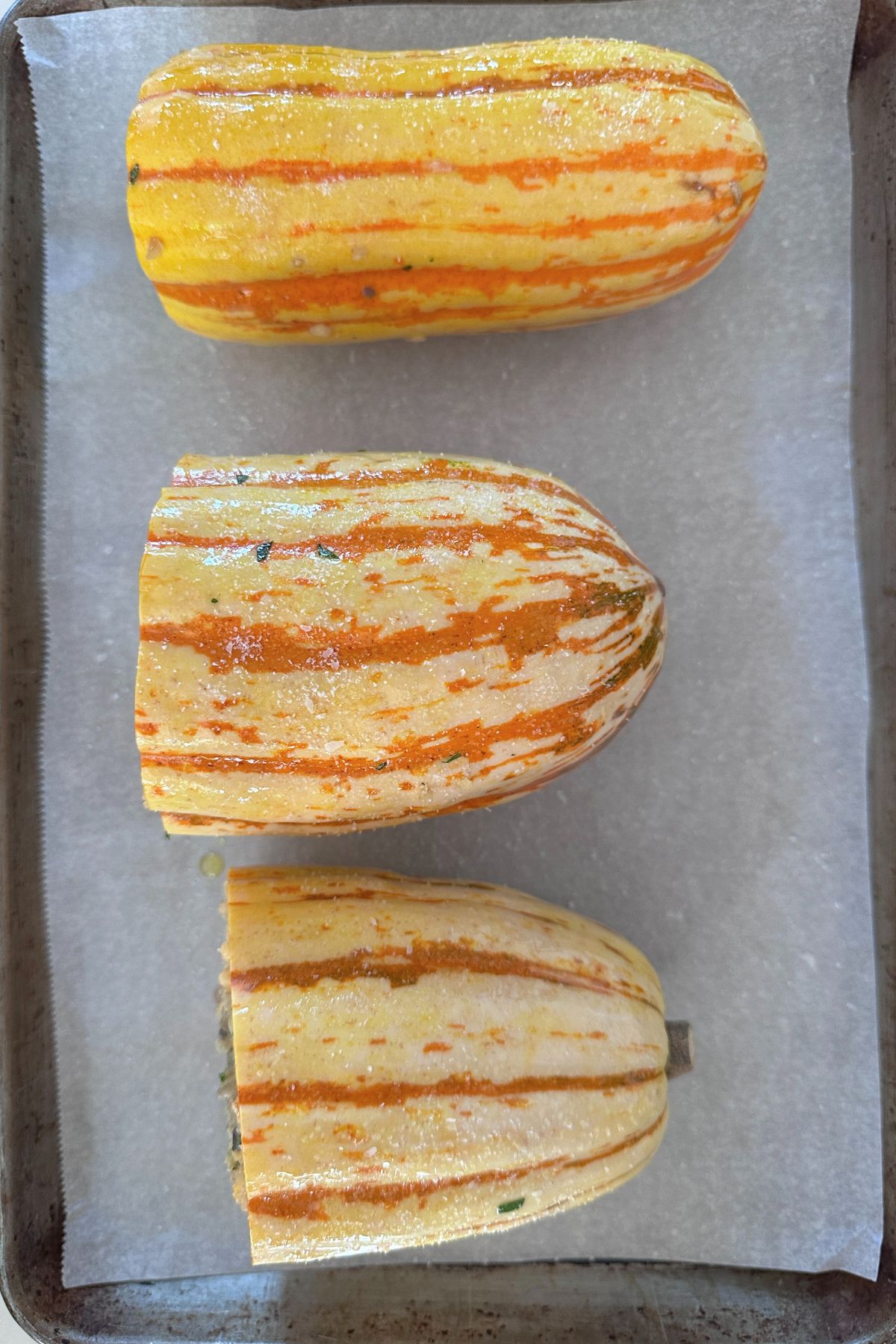Squash coated lightly with olive oil and salt and placed on a parchment lined baking sheet. 