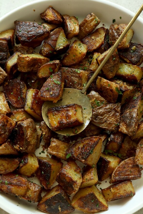 potatoes in a bowl with a serving spoon
