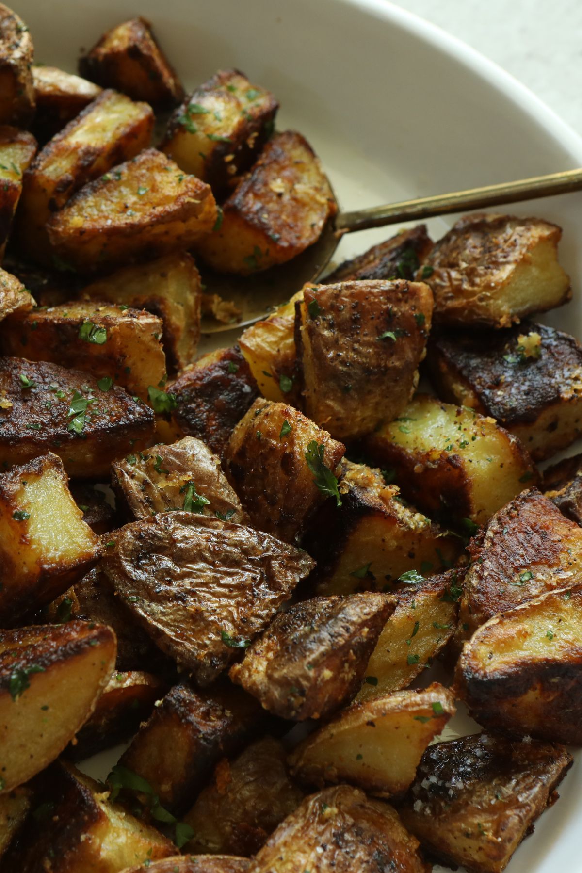 truffle potatoes in a bowl with a serving spoon