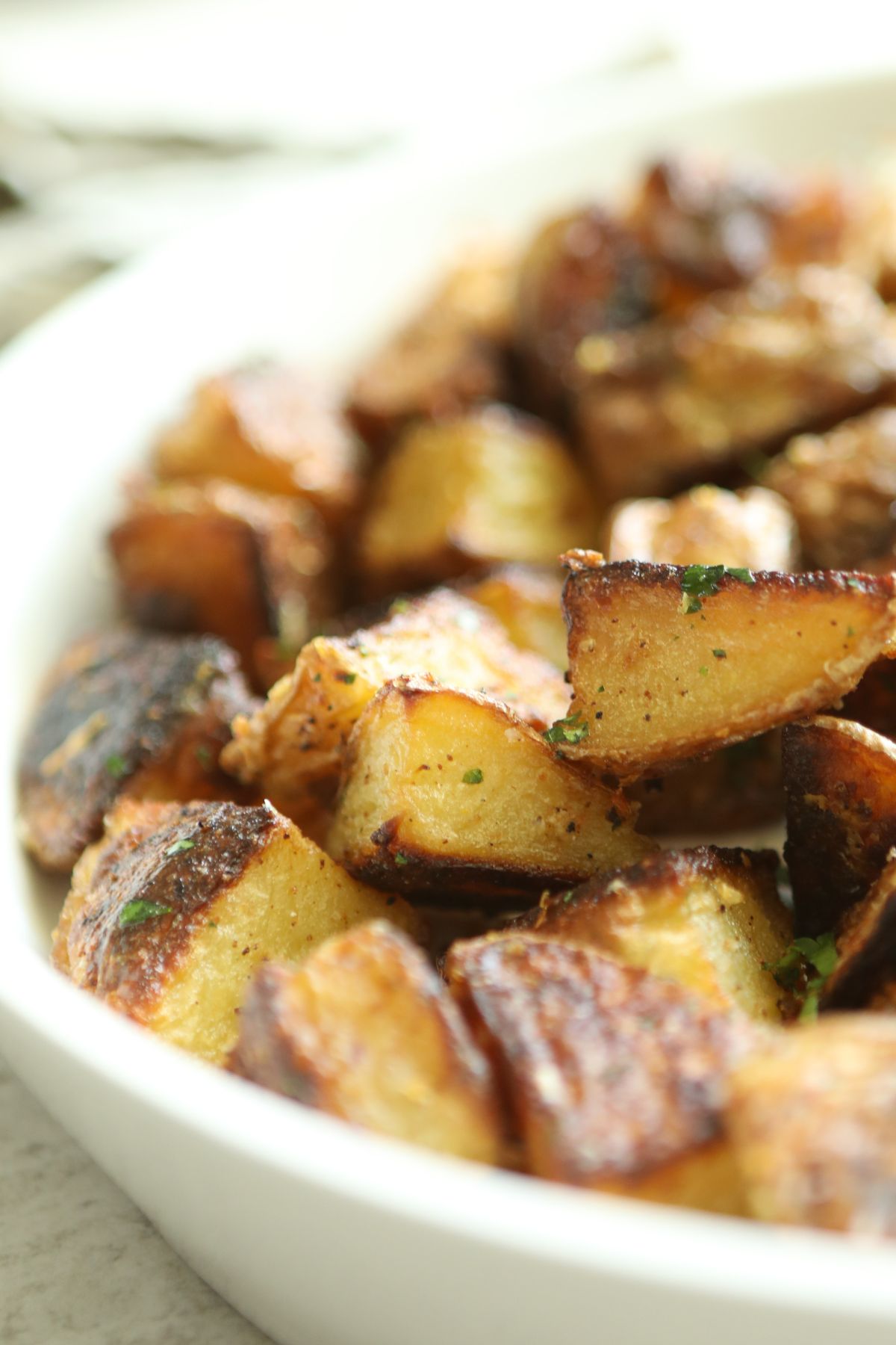 truffle potatoes in a white serving bowl 