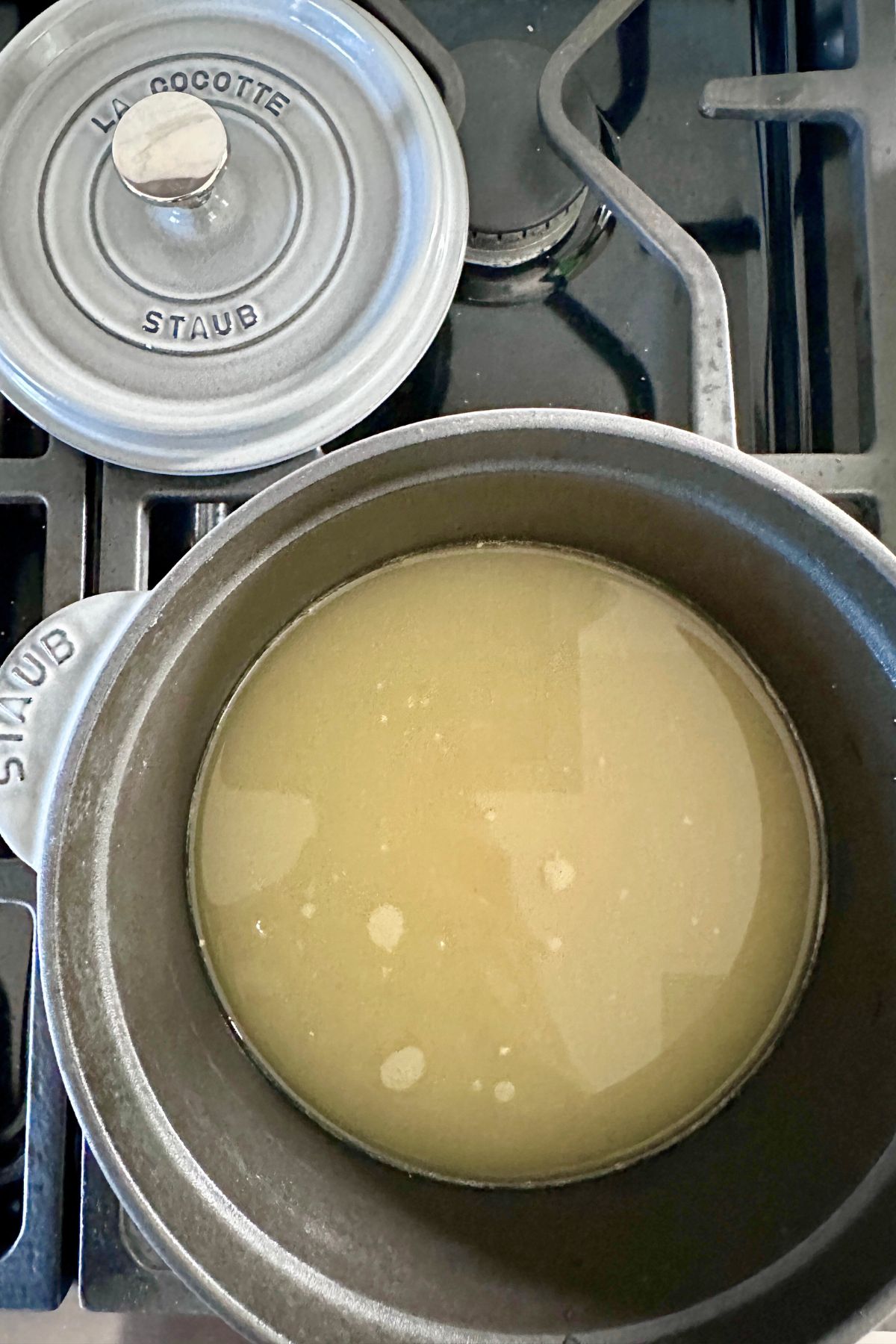 Broth in a medium saucepan on the stove, ready to simmer.